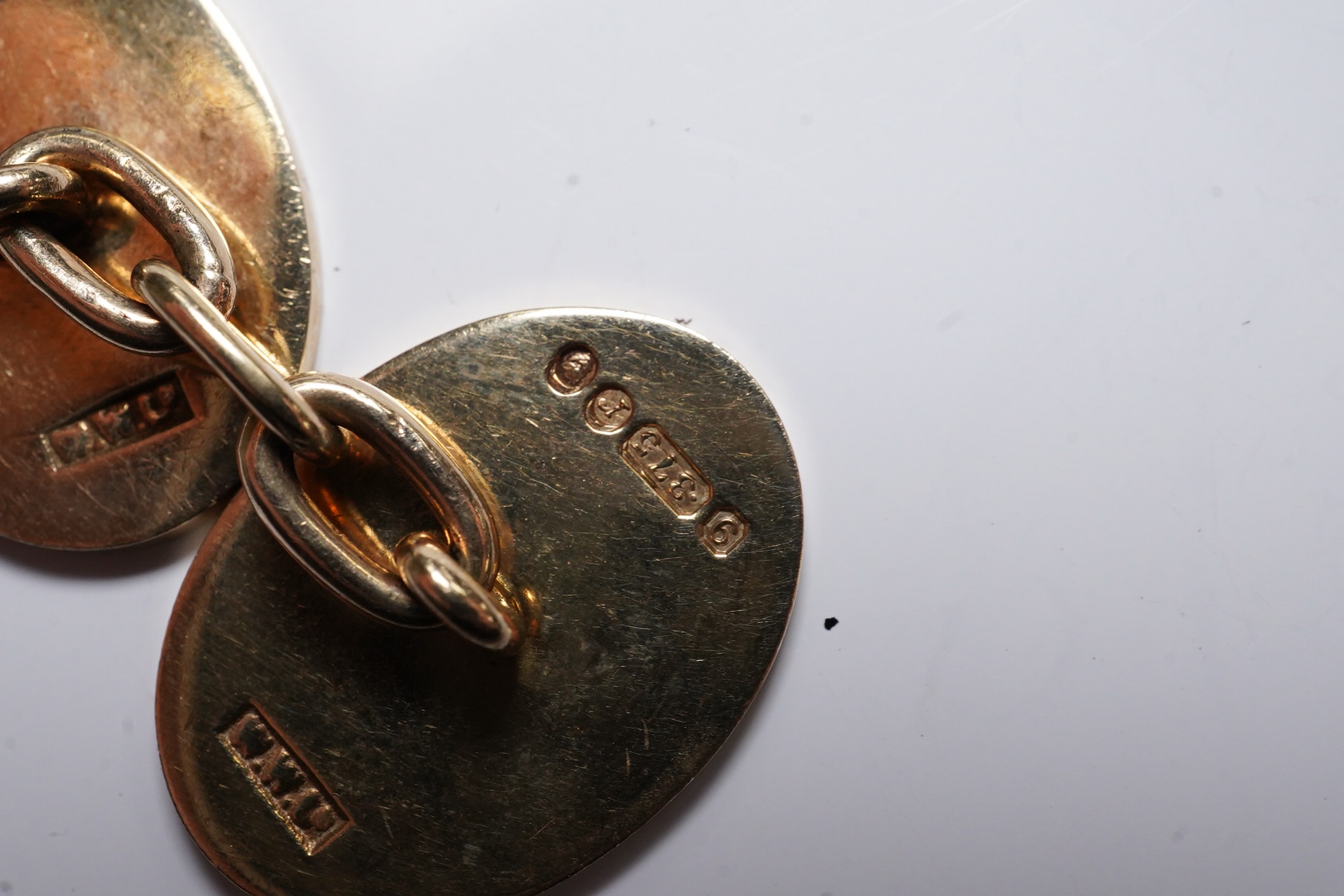 A pair of 1970's engraved 9ct gold oval cufflinks, 18mm, 11 grams. Condition - fair to good